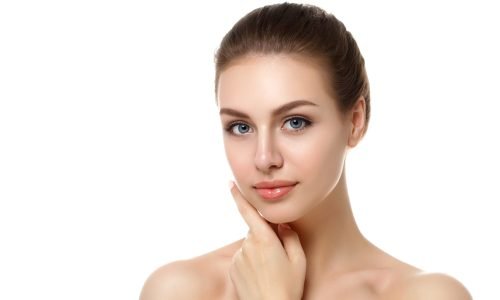 Portrait of young woman touching her face Portrait of young beautiful caucasian woman touching her face isolated over white background. Cleaning face, perfect skin. SPA therapy, skincare, cosmetology, hair removal or plastic surgery concept
